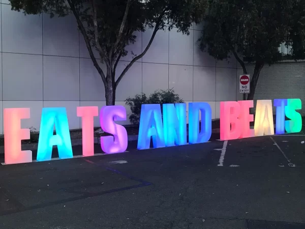 glow letters spelling out eats and beats